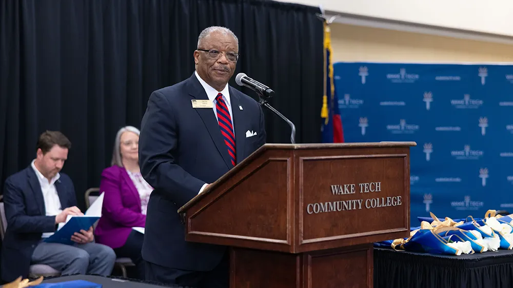 Wake County Commissioner Don Mial speaks during Wake Tech's Phi Theta Kappa induction ceremony.