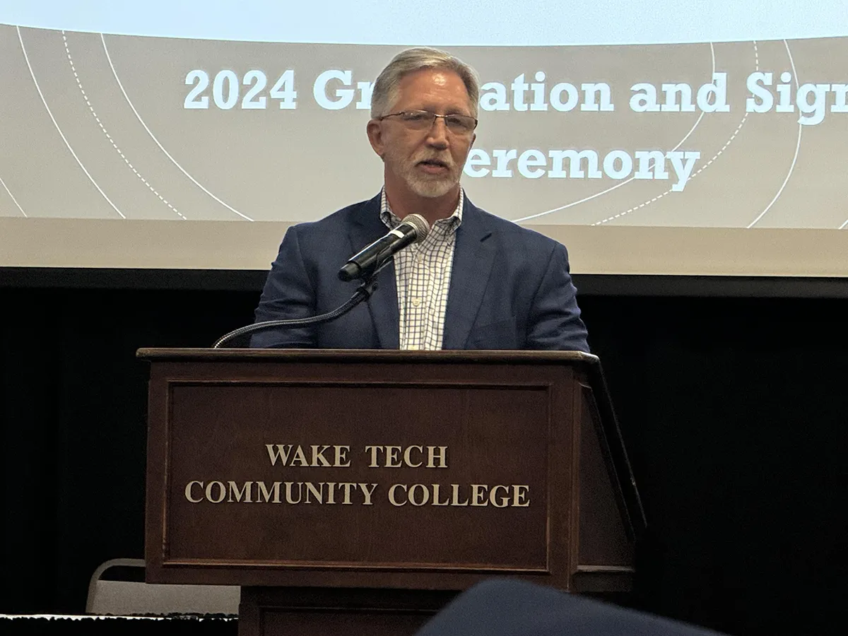 Wake Tech President Dr. Scott Ralls speaks to apprentices at the NCTAP ceremony.