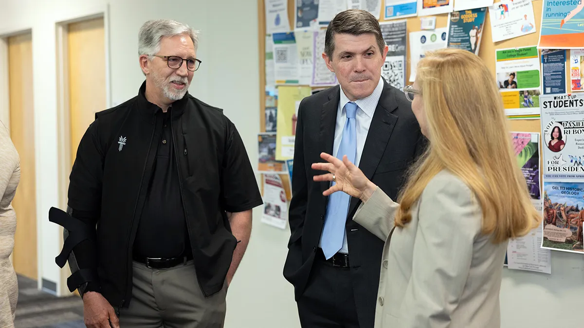 Wake Tech President Dr. Scott Ralls, left, and Executive Vice President Dr. Gayle Greene speak with North Carolina State Treasurer Brad Briner.
