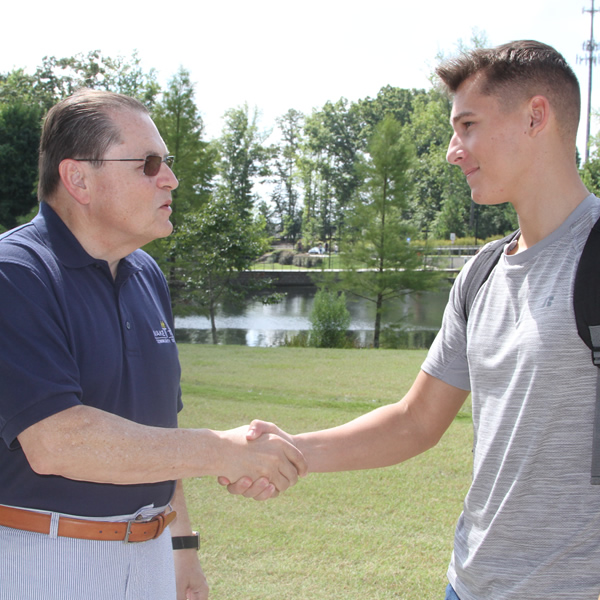 Dr. Scott greets student at North Campus