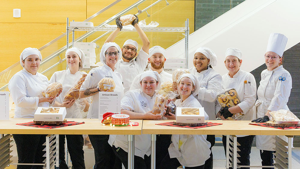 Wake Tech Baking & Pastry Arts students pose for a photo during the Bakers' Row event.