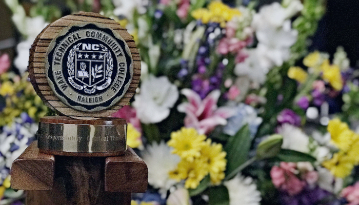 Wake Tech seal in front of flowers