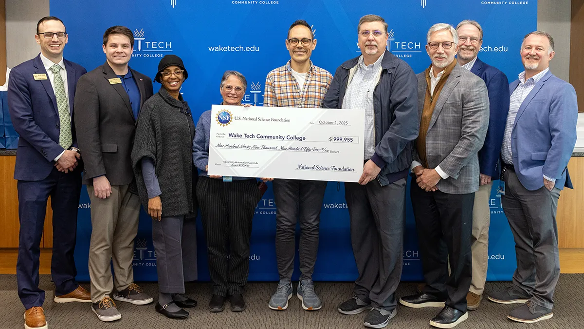 Wake Tech officials pose with a check symbolizing a National Science Foundation grant.