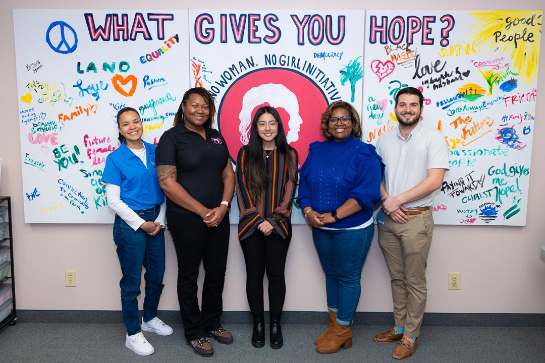 Wake Tech staff and leaders of the nonprofit No Woman, No Girl pose for a photo.