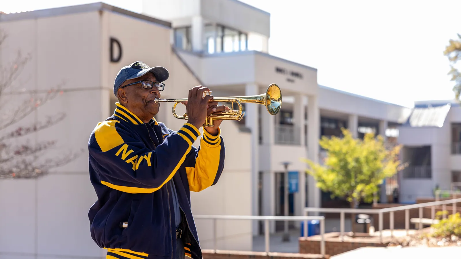 A veteran plays Taps during a ceremony at Wake Tech honoring military service members, veterans and their families.