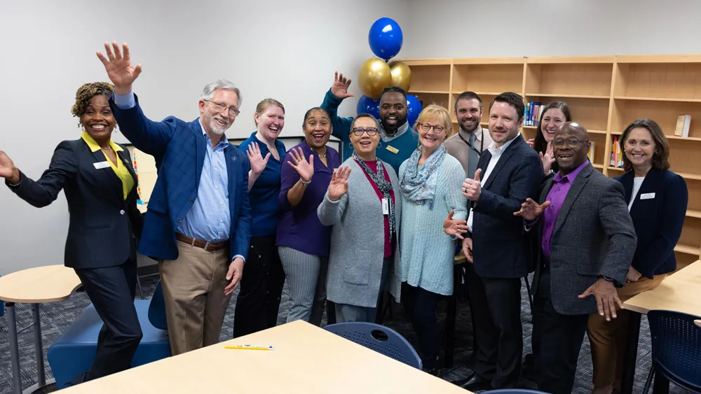 Wake Tech administrators and staff celebrate the opening of a library and tutoring space at the Beltline Education Center.