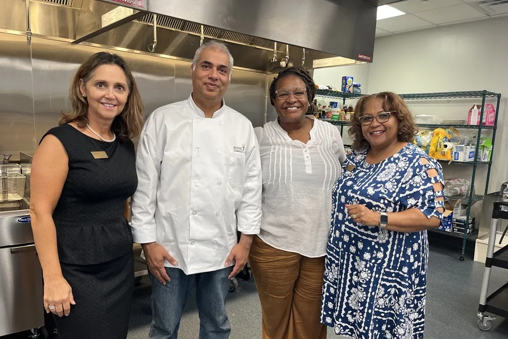 Wake Tech staff gather in the college's new training kitchen for careers in the hospitality industry.