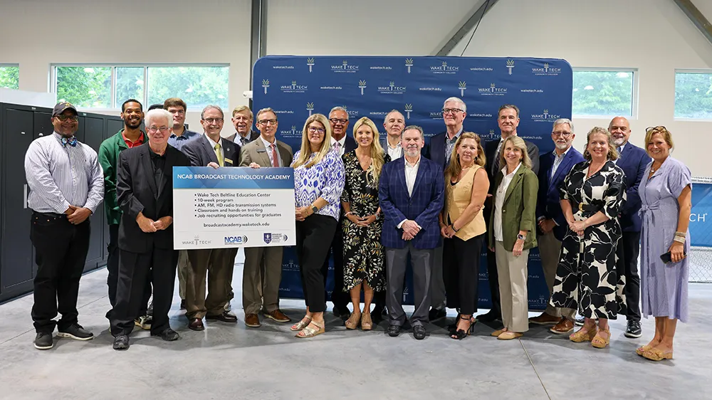Members of the first group of students in Wake Tech's Broadcast Technology Academy pose for a photo with college and N.C. Association of Broadcasters officials.