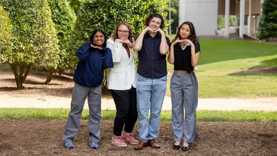 Four Wake Tech Peer Leaders pose for a photo.