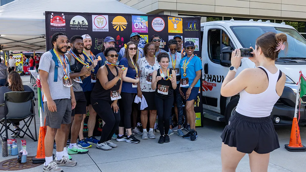 Runners celebrate finishing Reach, Rally & Run, Wake Tech’s annual run walk event supporting student success.