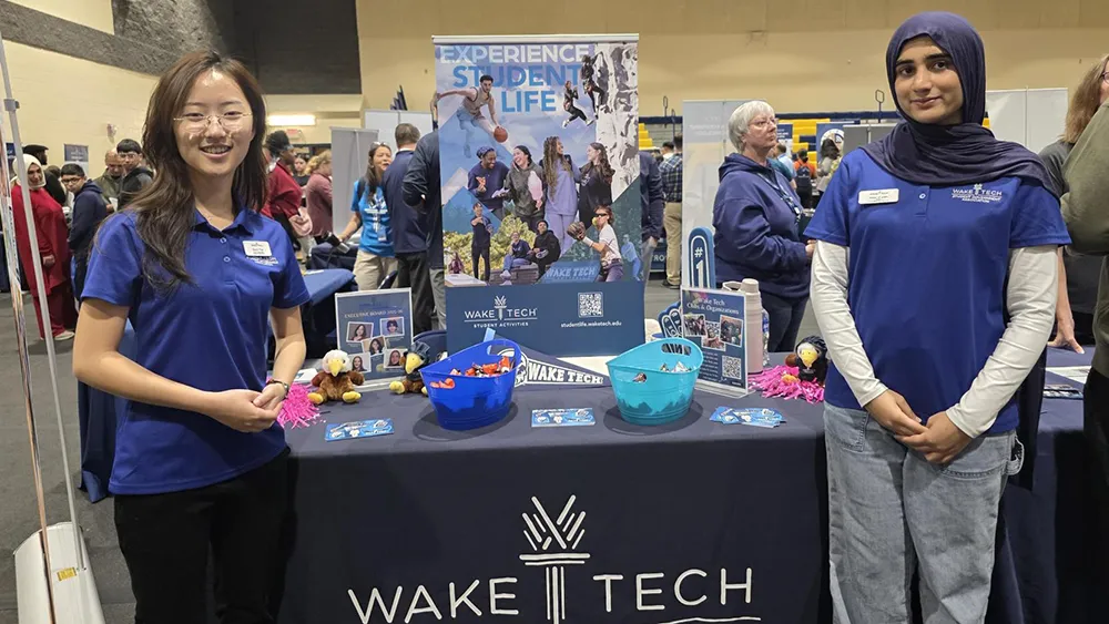 Two Wake Tech students are ready to provide information at the Student Activities booth during the college's Fall Open House.