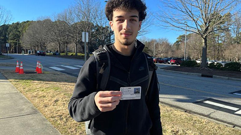 A Wake Tech student shows off his student ID