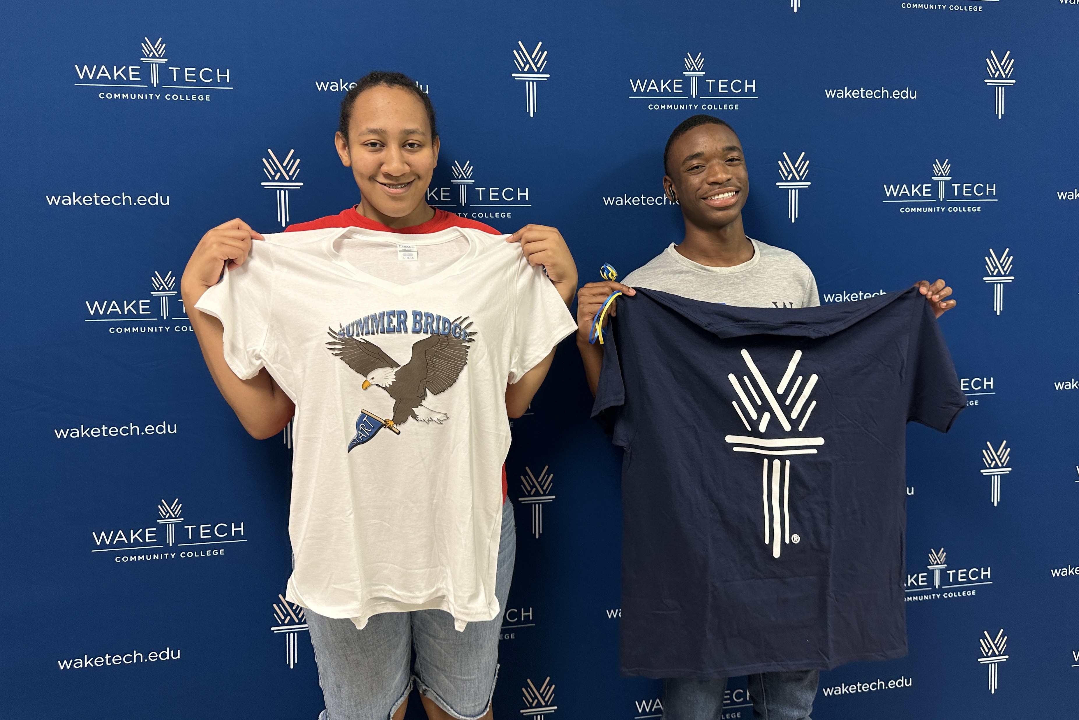 Two students who completed the six-week Eagle Start Summer Bridge program proudly display Wake Tech T-shirts as they prepare to start the Fall semester.