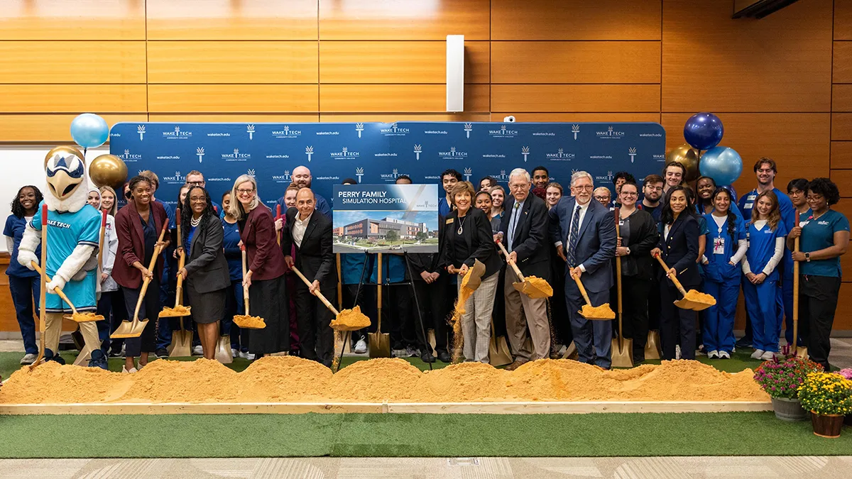 Wake Tech students and administrators and officials from Raleigh, Wake County and WakeMed hold a ceremonial groundbreaking for the college's Perry Family Simulation Hospital.