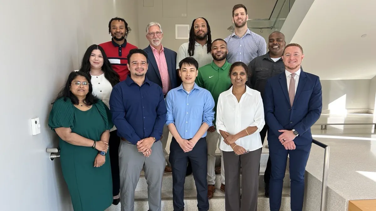 Some of the first students who completed Wake Tech's Sentinel Cybersecurity Bootcamp pose for a photo with college officials.