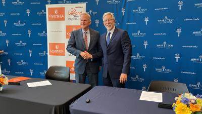 The presidents of Wake Tech and Campbell University sign a transfer partnership agreement.