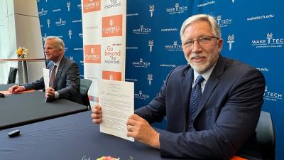 The presidents of Wake Tech and Campbell University sign a transfer partnership agreement.