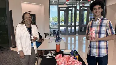 Three Wake Tech students gather at a table.