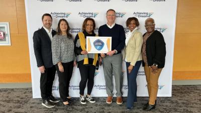 Wake Tech officials pose with the college's Leader College plaque.