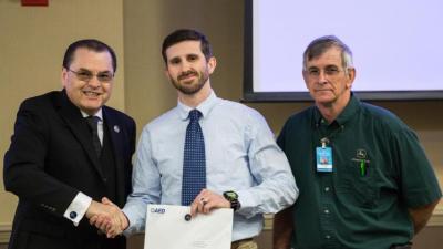 Dr. Stephen Scott, Wake Tech President; Joshua Schmidt, student; Ronnie Lowe, Heavy Equipment & Transport Technology