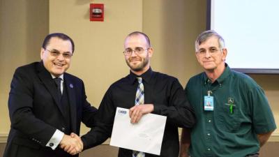 Dr. Stephen Scott, Wake Tech President; Joshua Schmidt, student; Ronnie Lowe, Heavy Equipment & Transport Technology