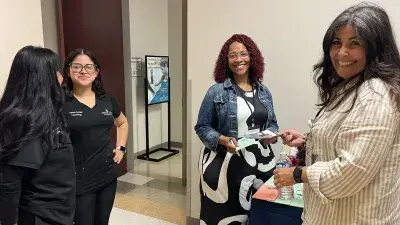 A Wake Tech staff member discusses the ESL program with a prospective student during the Open House en Español.