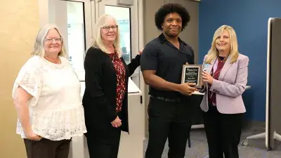 Wake Tech's 2024-25 Work-Based Learning Student of the Year George Dale poses for a photo with, left to right, IT Service & Support Assistant Professor Rebecca Sayers, Red Cross IT Service Desk Manager Debbie Walston and Kathy Frederick, director of Wake Tech's Work-Based Learning program.