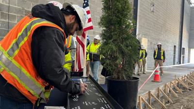 College Holds Topping-Out Ceremony for First Building at Future Campus