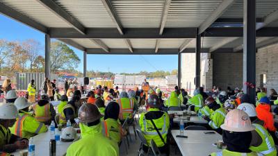 College Holds Topping-Out Ceremony for First Building at Future Campus