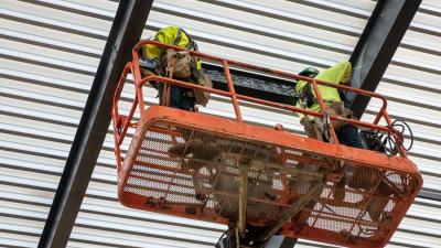 College Holds Topping-Out Ceremony for First Building at Future Campus