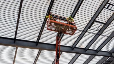 College Holds Topping-Out Ceremony for First Building at Future Campus