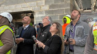 College Holds Topping-Out Ceremony for First Building at Future Campus