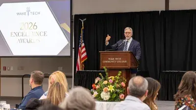 A table filled with trophies and plaques for Wake Tech Excellence Award winners