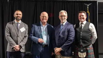 A table filled with trophies and plaques for Wake Tech Excellence Award winners