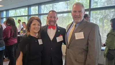 A table filled with trophies and plaques for Wake Tech Excellence Award winners