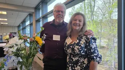 A table filled with trophies and plaques for Wake Tech Excellence Award winners