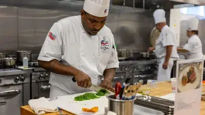 Members of Culinary Team USA prepare dishes for a fundraising dinner at Wake Tech that will help pay for expenses during the team's trip to Germany for the 2028 Culinary Olympics.