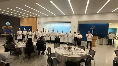 Members of Culinary Team USA prepare dishes for a fundraising dinner at Wake Tech that will help pay for expenses during the team's trip to Germany for the 2028 Culinary Olympics.