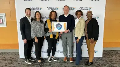 Wake Tech officials pose with the college's Leader College plaque.