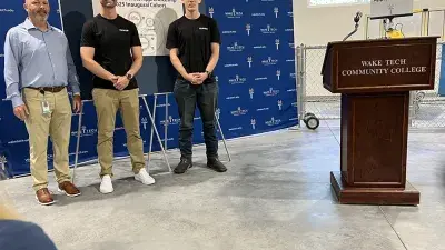 Officials speak during a ceremony marking the launch of Wake Tech's biomechantronics apprenticeship program.