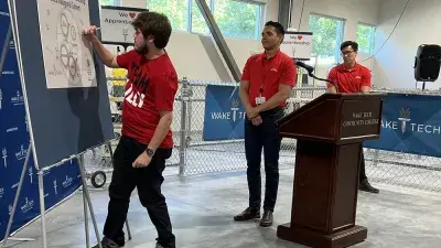 Officials speak during a ceremony marking the launch of Wake Tech's biomechantronics apprenticeship program.
