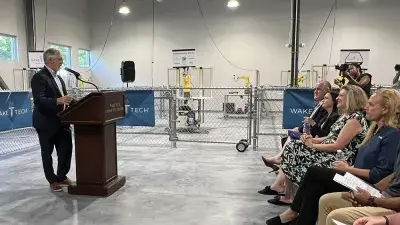 Officials speak during a ceremony marking the launch of Wake Tech's biomechantronics apprenticeship program.