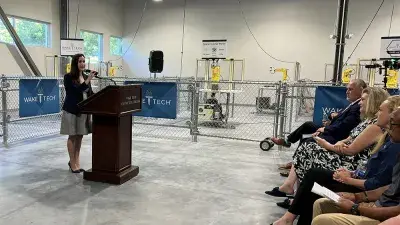 Officials speak during a ceremony marking the launch of Wake Tech's biomechantronics apprenticeship program.