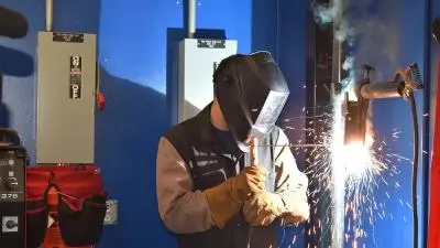 Student learning welding skills