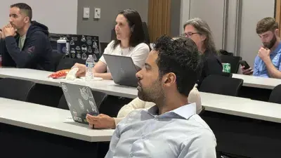 Wake Tech students and local business owners listen to a presentation during a cybersecurity workshop.