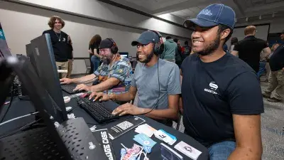 A man plays a video game created by Wake Tech students at the Simulation and Game Development annual Student Showcase.
