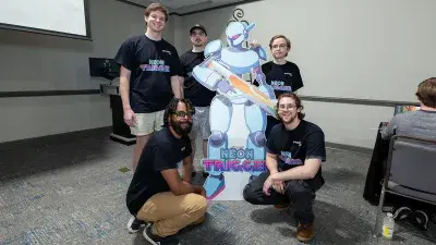 A man plays a video game created by Wake Tech students at the Simulation and Game Development annual Student Showcase.