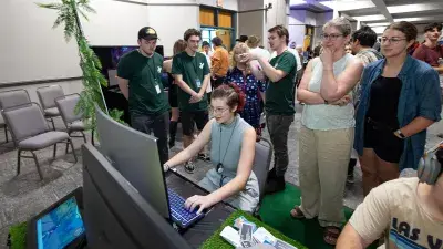 A man plays a video game created by Wake Tech students at the Simulation and Game Development annual Student Showcase.