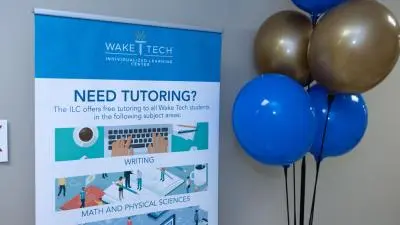 Wake Tech administrators and staff celebrate the opening of a library and tutoring space at the Beltline Education Center.