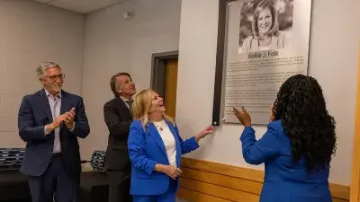 Kellie J. Faulk looks at the sign in a Southern Wake Campus building that now bears her name.